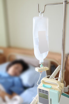 Inpatient on bed with bottle dextrose in hospital.