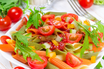 Colorful pasta on a white plate