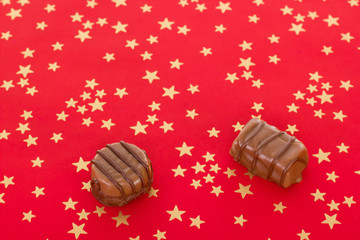 Two delicious home-made pralines on red background