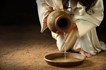 Jesus Pouring Water into Pan - obrazy, fototapety, plakaty