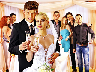 Wedding couple and guests drinking champagne.