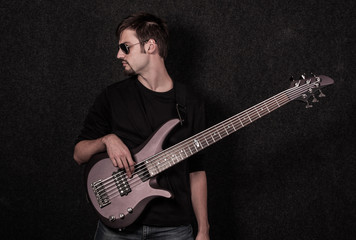 Man standing with bass guitar in studio