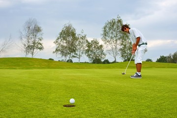 Golf, Golfer thrusting the ball into the hole