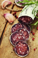 traditional sliced meat sausage salami on wooden board