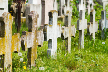 old graves headstones and crucifixes of a cemetery