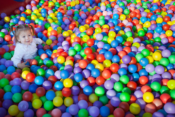 Fototapeta na wymiar little children on the background of many small balls