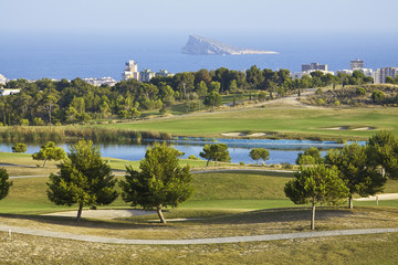 Golf place with nice green and lake at sunrise, Benidorm, Spain