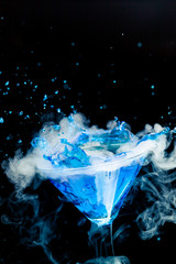blue cocktail with splash and ice vapor