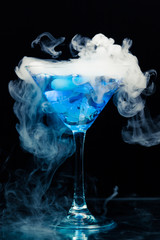 blue cocktail with splash and ice vapor