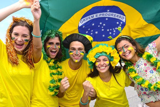 Group of happy brazilian soccer fans commemorating victory.
