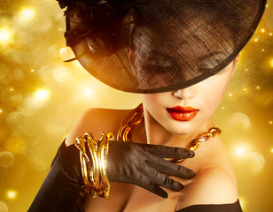 Luxurious Woman over Holiday Golden Background