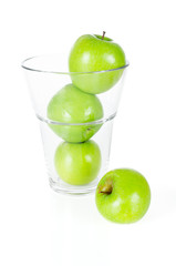Fresh green apples in glass isolated on white
