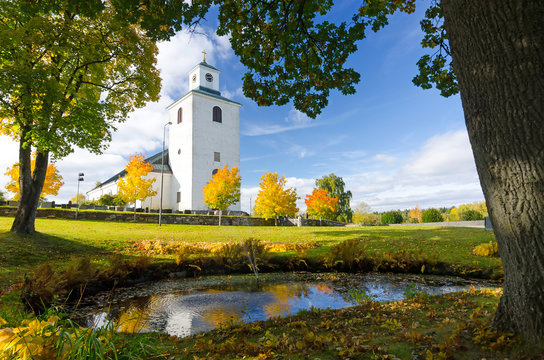 Swedish church with water reflection in autumn season
