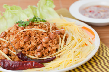 Crispy catfish with green mango salad, popular food in Thailand.