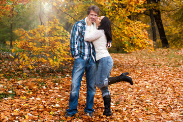 Happy couple in a park in autumn