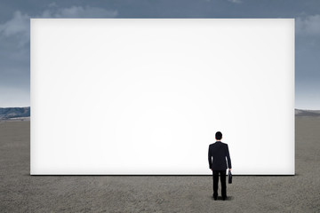 Businessman looking empty billboard