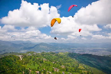 Paraglider flying against the Himalayas, Nepal.
