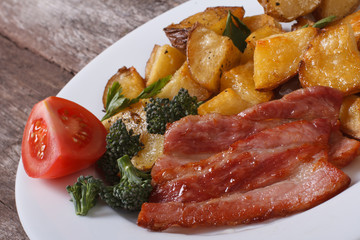 Baked potato with vegetables and bacon close-up