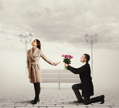 woman rejecting man with flowers