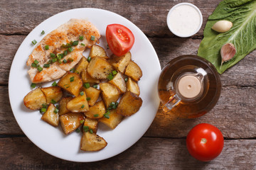 Baked potatoes with chicken steak and vegetables. top view