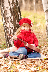 Funny little girl playing guitar