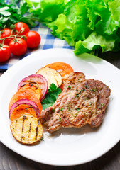 Steak with grilled vegetables on a plate