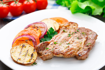 Steak with grilled vegetables on a plate