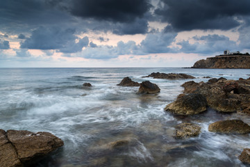 Stunning landscapedawn sunrise with rocky coastline and long exp