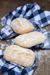 Panini rolls in rustic kitchen setting with cooking utensils