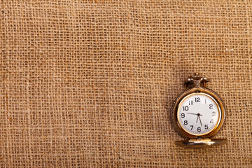 Classic pocket watch on burlap