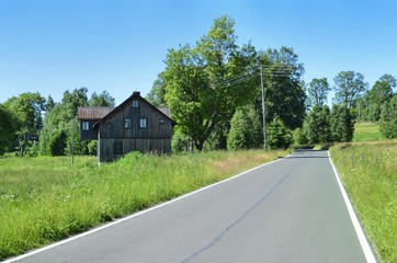 Road and old wooden house