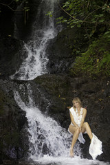 blond woman in a waterfall