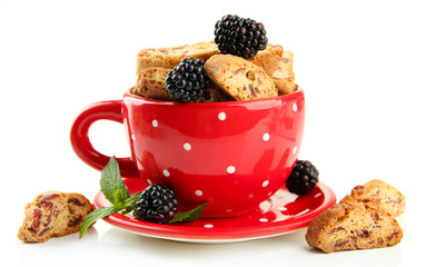 Tasty cookies with blackberry in cup isolated on white