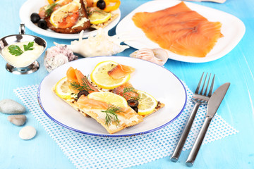 Salmon sandwiches on plate  on wooden table close-up