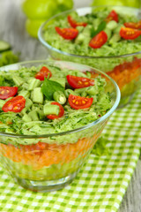 Tasty salad with fresh vegetables on wooden table