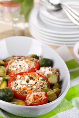 Stuffed tomatoes in bowl on wooden table close-up