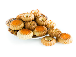 Different tasty cookies are on a white plate