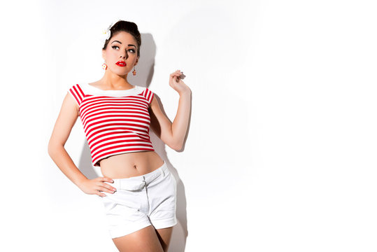 Sexy retro pin-up girl with red lipstick wearing red striped shi