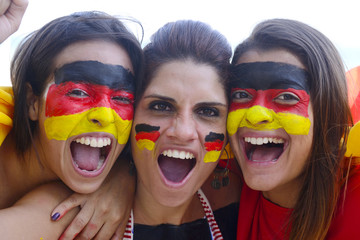 Group of happy german soccer fans commemorating victory.