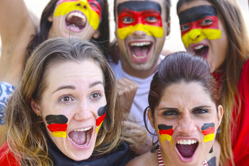 Group of happy german soccer fans commemorating victory.