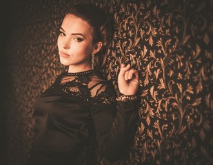 Beautiful young girl wearing black evening dress 