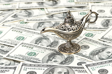aladdin lamp on dollar background