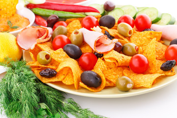 Nachos, olives, pork loin and vegetables