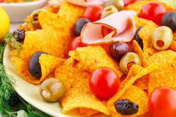 Nachos, olives, pork loin and vegetables