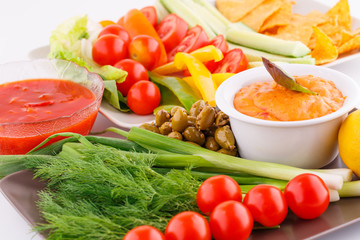 Vegetables, olives, nachos, red and cheese sause