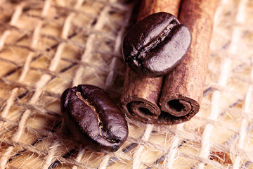 two coffee beans on cinnamon stick