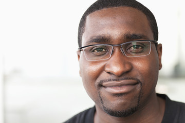 Portrait of smiling businessman with glasses looking at camera