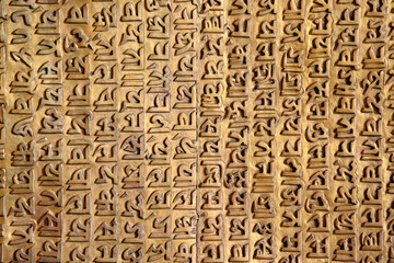 Ancient Sanskrit carving on a golden background - obrazy, fototapety, plakaty