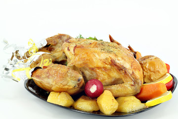roasted chicken with potatoes on plate