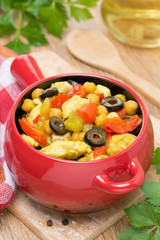 chicken stew with chickpeas and vegetables in the pot, close-up